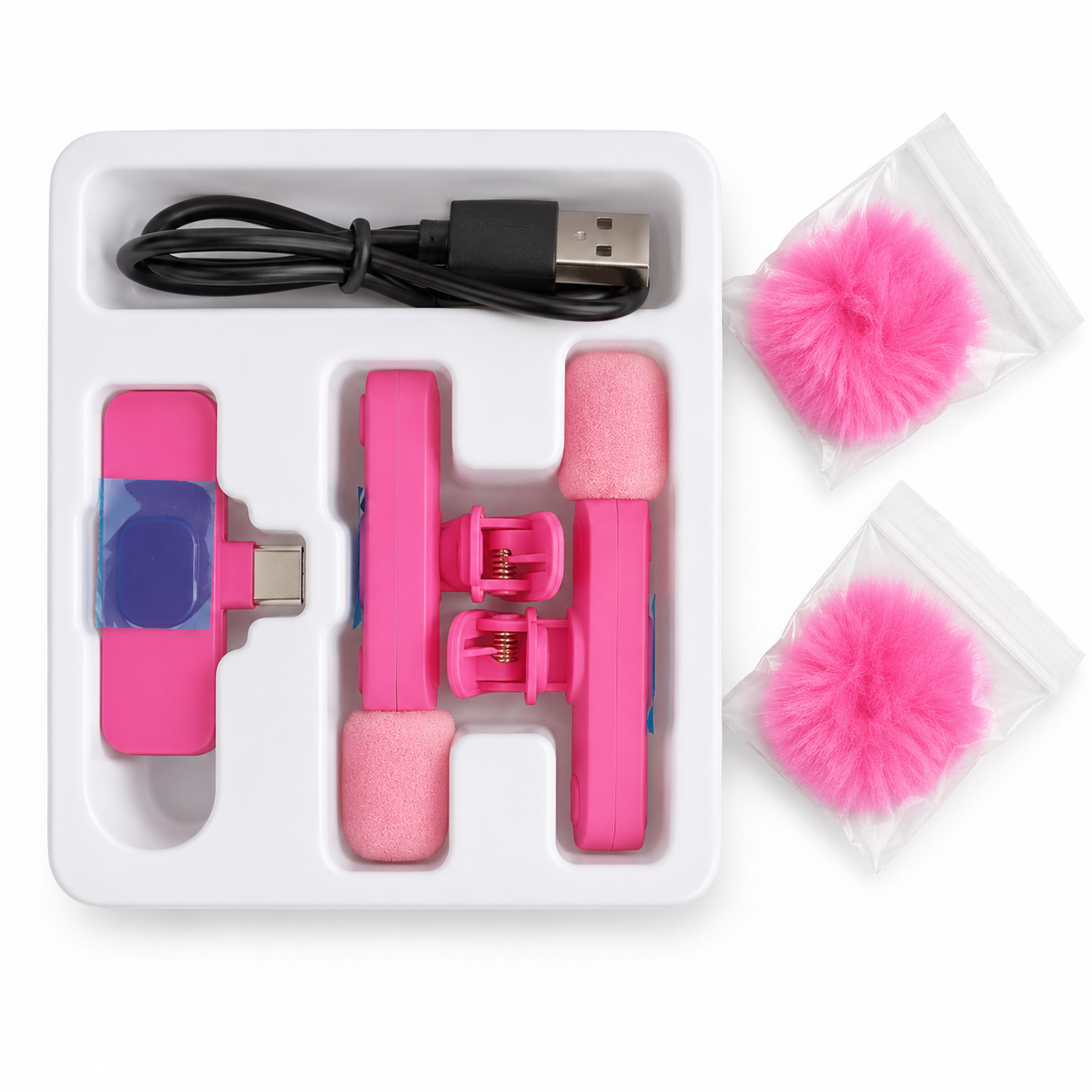 Pink electronic device with USB cable and cleaning pads in a white box on a white background