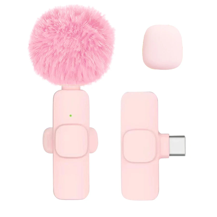 Pink microphone with fluffy pink ball and USB connector on a white background