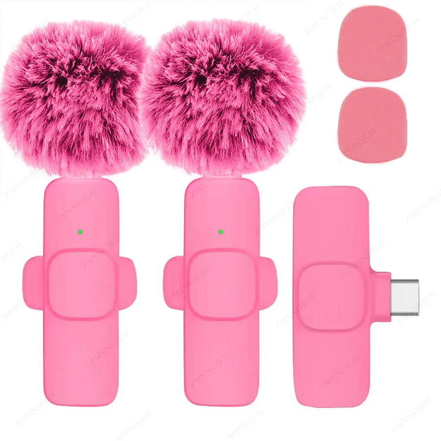 Pink microphone with fluffy windshields and attachments on a white background